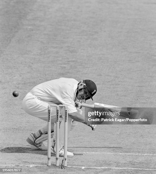 Robin Smith of England ducks a bouncer from Ian Bishop of West Indies on day three of the 3rd Test match between England and West Indies at...