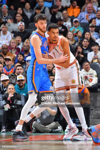 Chet Holmgren of the Oklahoma City Thunder and Victor Wembanyama of the San Antonio Spurs play defense during the game on January 24, 2024 at the...