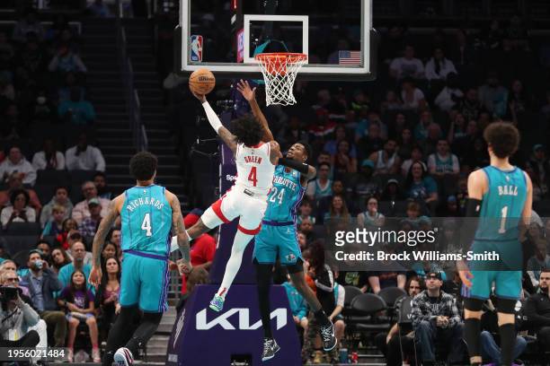 Jalen Green of the Houston Rockets drives to the basket during the game as Brandon Miller of the Charlotte Hornets plays defense on January 26, 2024...