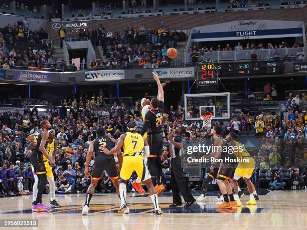 Myles Turner of the Indiana Pacers and Jusuf Nurkic of the Phoenix Suns go for the opening tip-off on January 26, 2024 at Gainbridge Fieldhouse in...