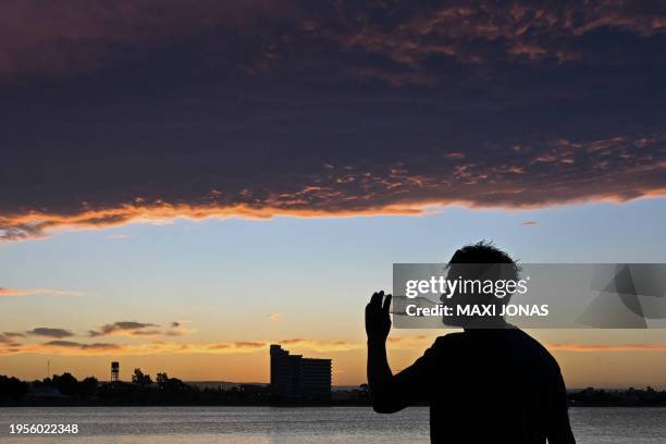 Man drinks water under the sun on a beach in Puerto Madryn, Chubut province, Argentina on January 26, 2024. Argentine Patagonia, a huge geographical...