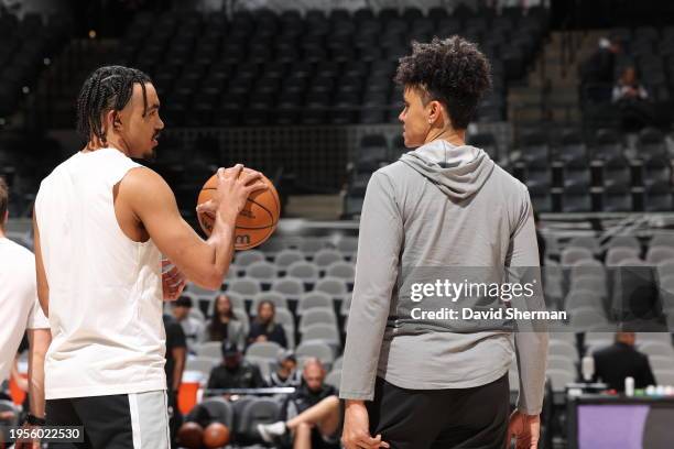 Tre Jones of the San Antonio Spurs and Assistant Coach Candice Dupree warm up before the game against the Portland Trail Blazers on January 6, 2024...