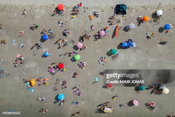 Aerial view of people under the sun on a beach in Puerto Madryn, Chubut province, Argentina on January 26, 2024. Argentine Patagonia, a huge...