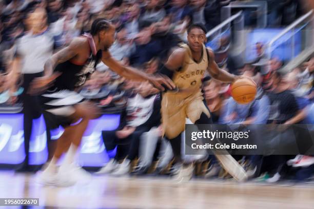 Barrett of the Toronto Raptors dribbles against Kawhi Leonard of the LA Clippers during the first half of their NBA game at Scotiabank Arena on...