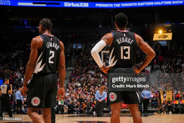 Kawhi Leonard and Paul George of the LA Clippers look on during the game against the Toronto Raptors on January 26, 2024 at the Scotiabank Arena in...
