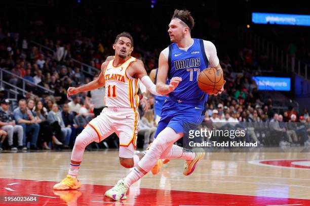 Luka Doncic of the Dallas Mavericks drives to the basket against Trae Young of the Atlanta Hawks during the first quarter at State Farm Arena on...