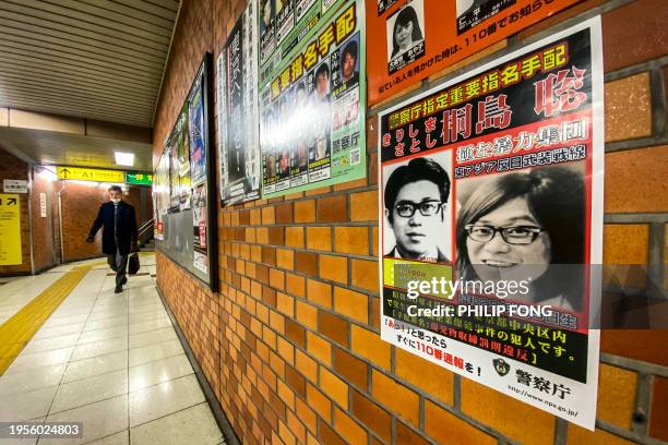 This picture taken on January 26, 2024 in a train station of Chuo district in Tokyo shows a poster of Satoshi Kirishima, who was a member of The East...