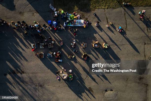 Locals line up for food and clothing that is donated by the Qtmc Inc charity in Pontiac, Michigan, Thursday, January 4, 2024.