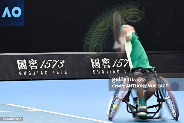 Japan's Tokito Oda serves against Britain's Alfie Hewett during their men's wheelchair singles final match on day 14 of the Australian Open tennis...