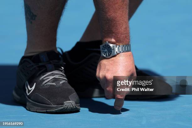 The surface on Court 3 is inspected by Tennis Australia personal during the 2024 Australian Open at Melbourne Park on January 24, 2024 in Melbourne,...