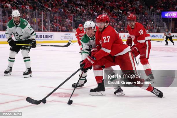 Michael Rasmussen of the Detroit Red Wings battles for the puck with Nils Lundkvist of the Dallas Stars during the second period at Little Caesars...