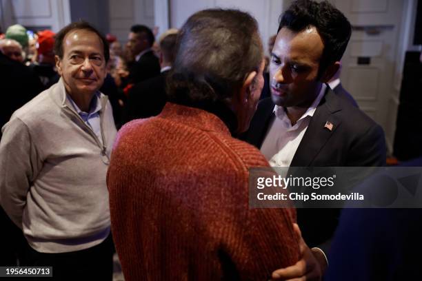 Former Republican presidential candidate Vivek Ramaswamy talks with billionaires John Paulson and Steve Wynn at the conclusion of a primary victory...