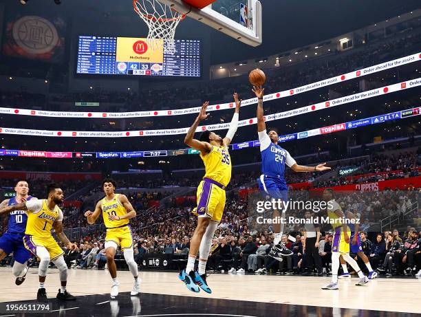 Norman Powell of the LA Clippers takes a shot against Christian Wood of the Los Angeles Lakers in the first half at Crypto.com Arena on January 23,...