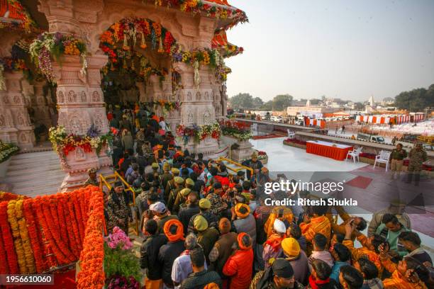 Devotees queue to get glimpse of a statue of the hindu god Ram one day after consecration ceremony of the Ram Mandir on January 23, 2024 in Ayodhya,...
