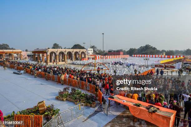 Devotees queue to get glimpse of a statue of the hindu god Ram one day after consecration ceremony of the Ram Mandir on January 23, 2024 in Ayodhya,...