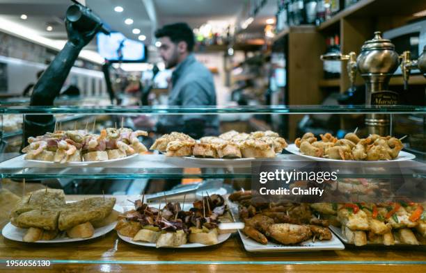 locals enjoying pintxos( pincho or tapas) in san sebastián,basque,spain - san sebastian spain stock pictures, royalty-free photos & images