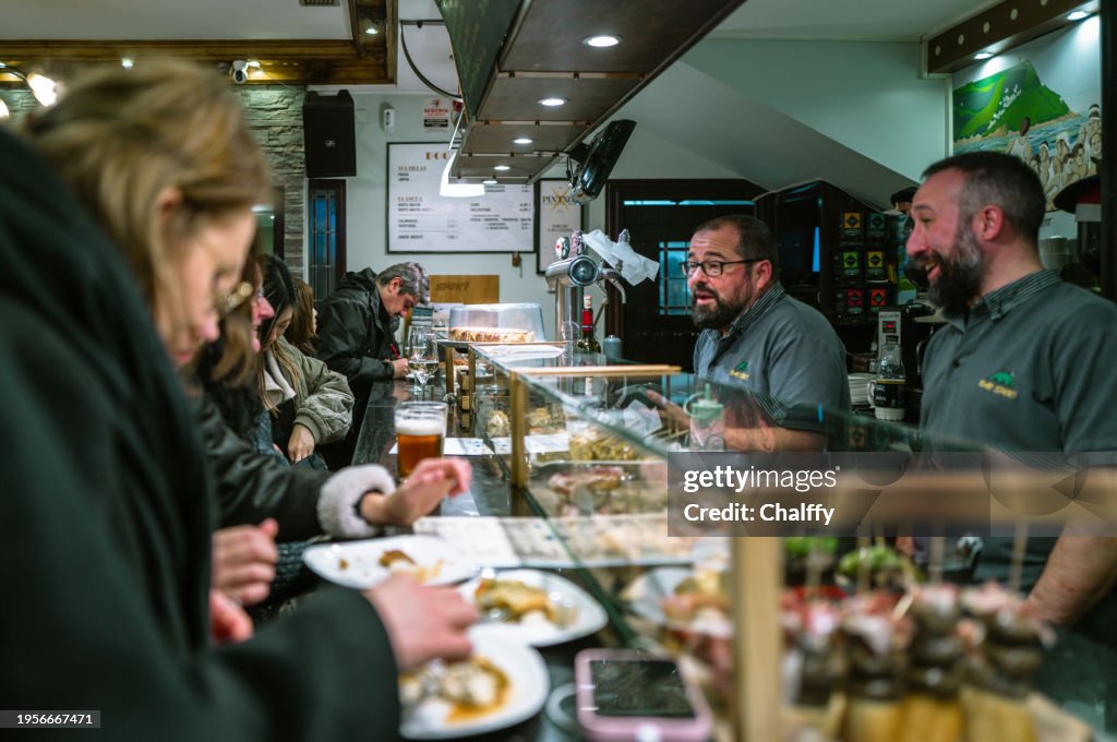 Locals Enjoying Pintxos( Pincho or Tapas) in San Sebastián,Basque,Spain