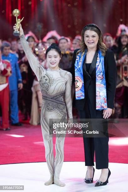 Acrobat Wang Mengchen of the Jiangsu Chinese Acrobatic Troupe receives the Junior Gold Award from Camille Gottlieb during the 46th International...