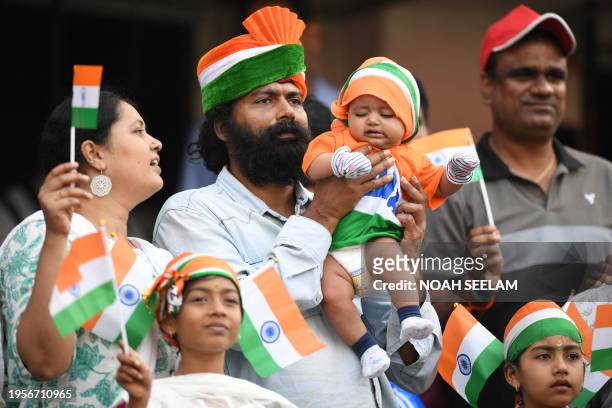 Cricket fans weave Indian flags in the stands during the third day of the first Test cricket match between India and England at the Rajiv Gandhi...