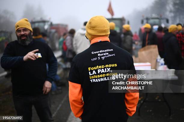 Farmer of the CR47 union with a union shirt reading "leave us alone, let us work" attends a blocking of the A62 highway near Agen, southwestern...