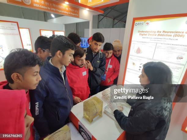 Brain scientist Archana Pawar shows an actual human brain preserved from a cadaver on display at a science fair the India International Science...