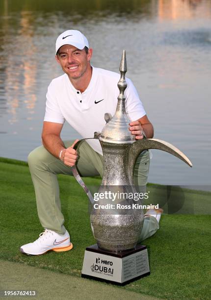 Rory McIlroy of Northern Ireland poses for a photo with the trophy on the 18th green after winning the 2024 Hero Dubai Desert Classic at Emirates...