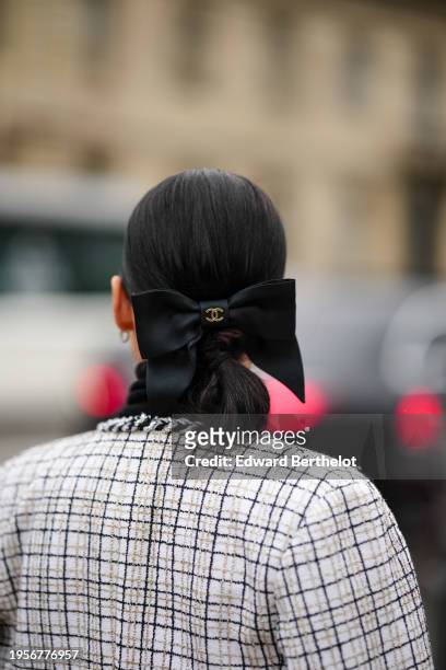 Clara Cornet wears a black bow Chanel hair ribbon, outside Chanel, during the Haute Couture Spring/Summer 2024 as part of Paris Fashion Week on...