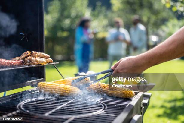 corn being roasted on grill - i was turning into a vegetable stock pictures, royalty-free photos & images