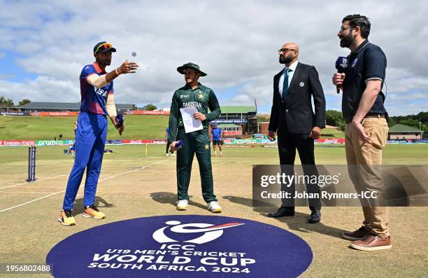 Dev Khanal of Nepal flips the coin as Saad Baig of Pakistan looks on ahead of the ICC U19 Men's Cricket World Cup South Africa 2024 match between...