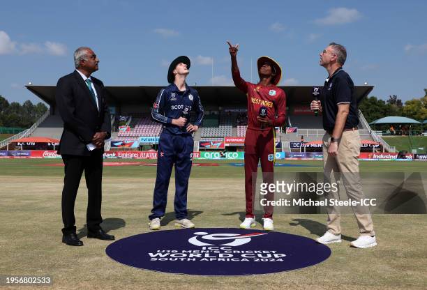 Stephan Pascal of West Indies flips the coin as Owen Gould of Scotland looks on ahead of the ICC U19 Men's Cricket World Cup South Africa 2024 match...