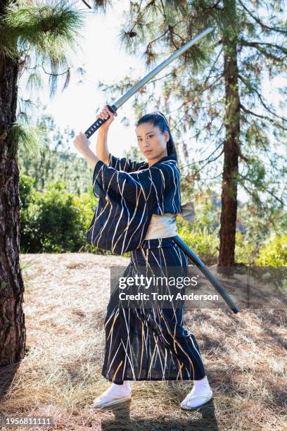 woman in kimono practicing martial arts with sword - sandal tree stock pictures, royalty-free photos & images