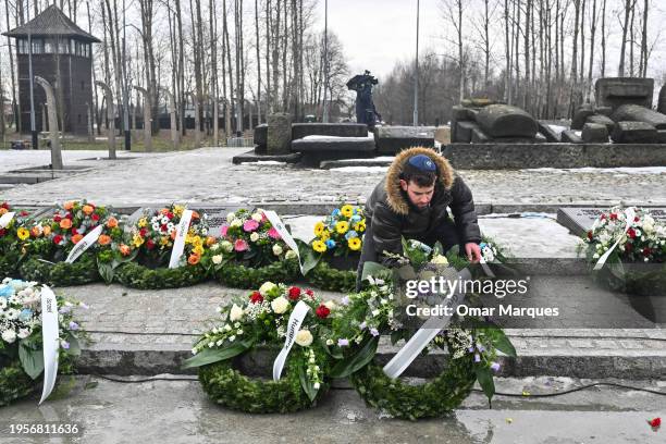 Member of the organization carries a wreaths as he takes part in a ceremony by the International monument for the victims of fascism during a visit...