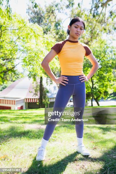 teenage girl in athletic wear standing outdoors - filipino girl stock pictures, royalty-free photos & images