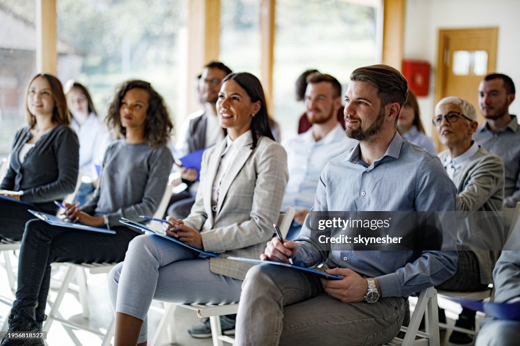 Crowd of business people having a seminar in board room.