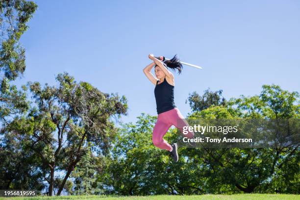 woman jumping with sword - swing sword stock pictures, royalty-free photos & images