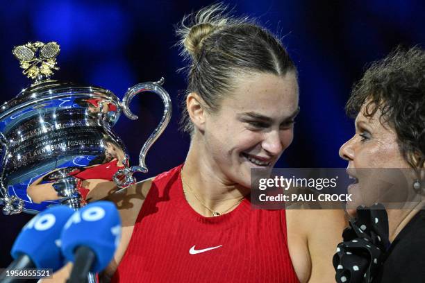 Belarus' Aryna Sabalenka speaks Australia's former tennis player Evonne Goolagong as she poses with the Daphne Akhurst Memorial Cup after victory...