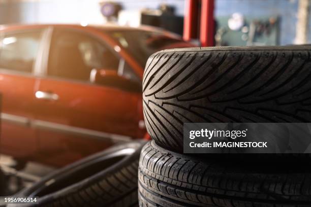 car tires in the foreground - neumático fotografías e imágenes de stock
