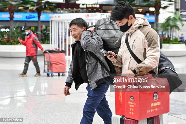 Travelers are seen at the waiting hall of Guangzhou South Railway Station ahead of the Spring Festival travel rush on January 24, 2024 in Guangzhou,...