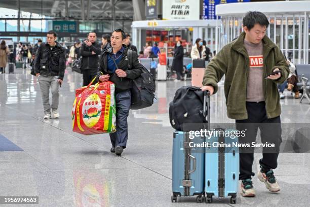 Travelers are seen at the waiting hall of Guangzhou South Railway Station ahead of the Spring Festival travel rush on January 24, 2024 in Guangzhou,...