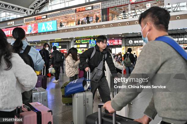 Travelers are seen at the waiting hall of Guangzhou South Railway Station ahead of the Spring Festival travel rush on January 24, 2024 in Guangzhou,...