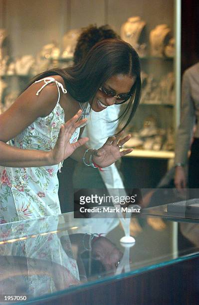 Model Naomi Campbell gestures as she stops at a store along Madison Avenue while on a shopping spree April 28, 2003 in New York City. Naomi shopped...
