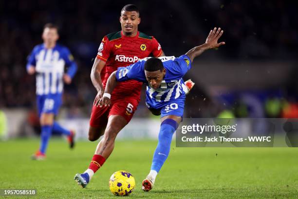 Pervis Estupinan of Brighton & Hove Albion is challenged by Mario Lemina of Wolverhampton Wanderers during the Premier League match between Brighton...