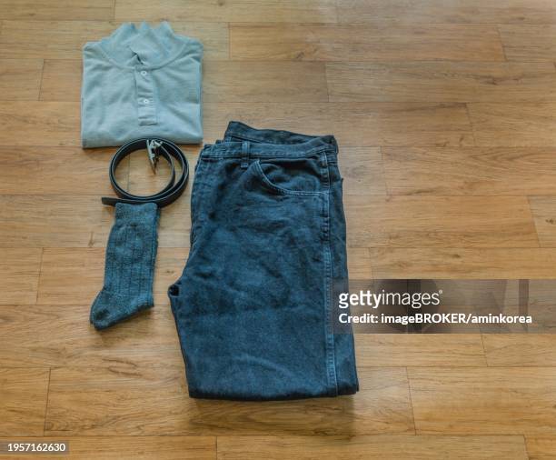 flat-lay image of black jeans, gray two button pullover, gray crew socks and black belt on wood grain background, south korea, south korea, asia - gray belt stock pictures, royalty-free photos & images