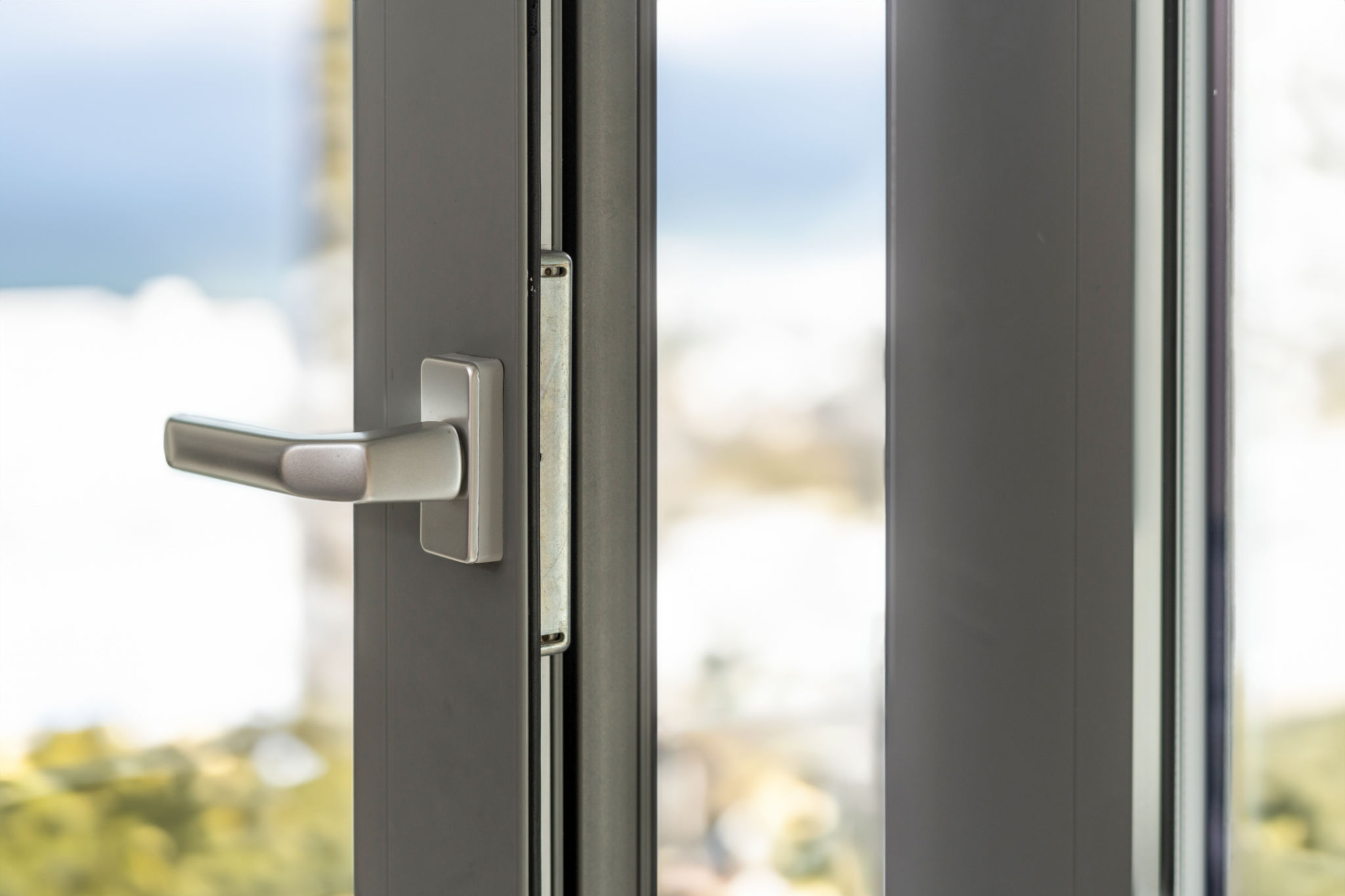 Close up of metal lock of pvc or aluminum frame of window with silver handle. Close up of metal lock of pvc or aluminum frame of window with silver handle.