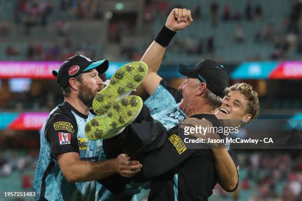 Michael Neser, Andy Bichel and Spencer Johnson of the Heat celebrate victory during the BBL Final match between Sydney Sixers and Brisbane Heat at...