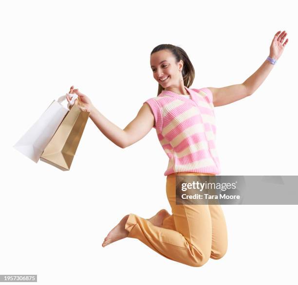 woman running with shopping bags - jump shot stock pictures, royalty-free photos & images