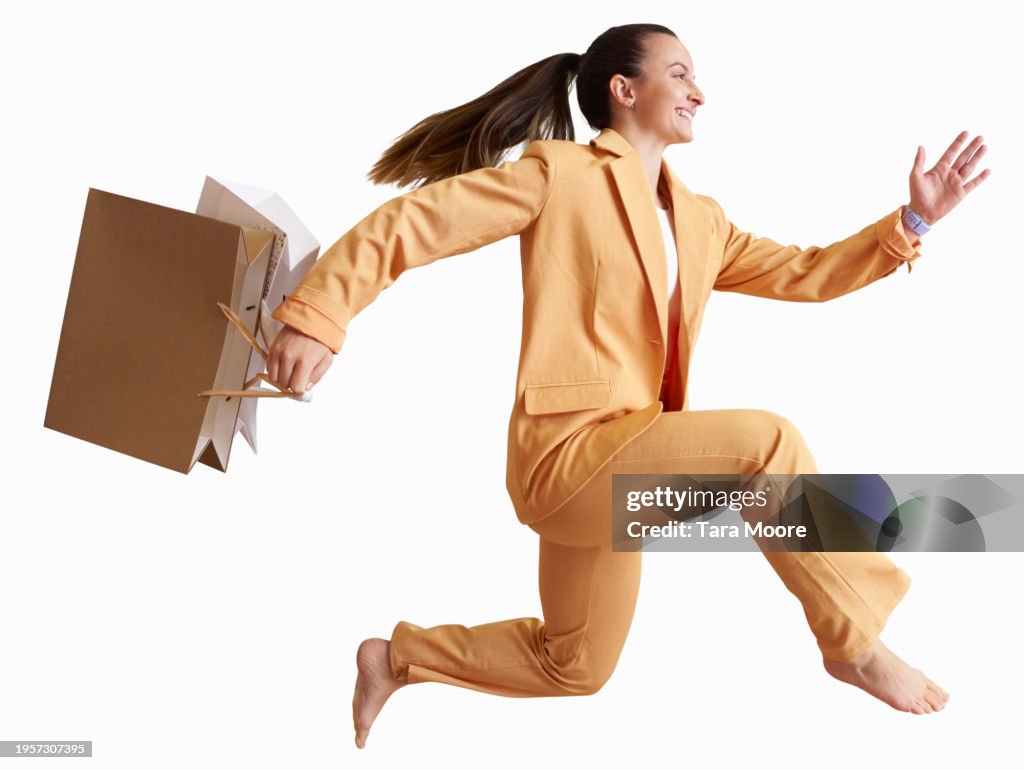Woman running with shopping bags