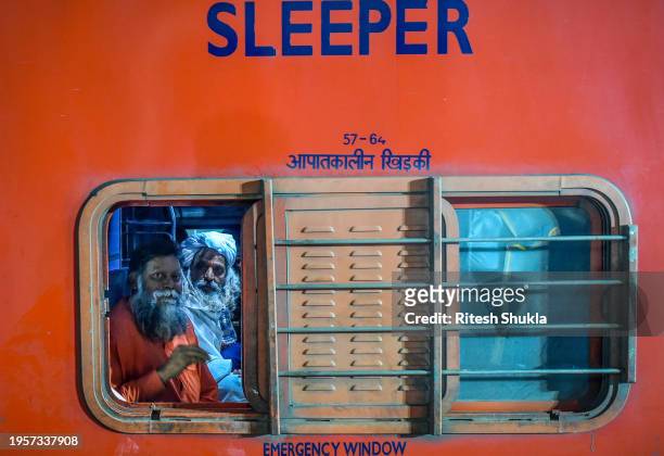 Devotees and pilgrims wait for their trains at Ayodhya railway station one day after consecration ceremony of the Ram Mandir on January 23, 2024 in...