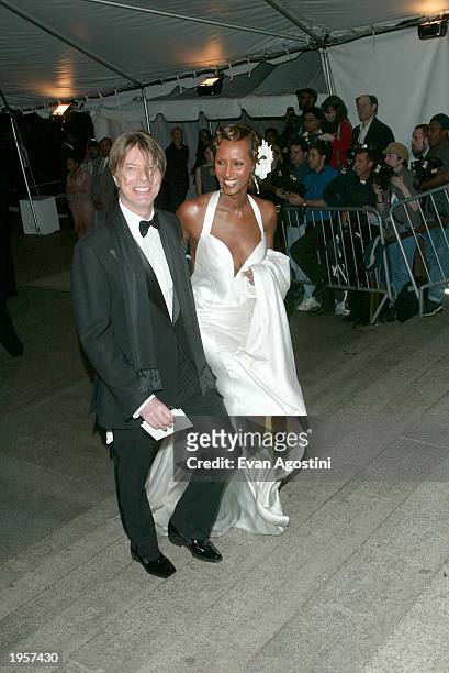 Musician David Bowie and wife model Iman arrive at the Metropolitan Museum of Art Costume Institute Benefit Gala sponsored by Gucci April 28, 2003 at...