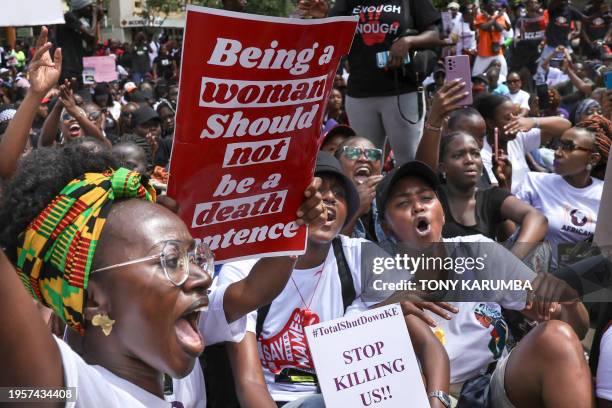 Activists hold up placards as they march through the Central Business District at a demonstration against an alarming rise in murders of young women...